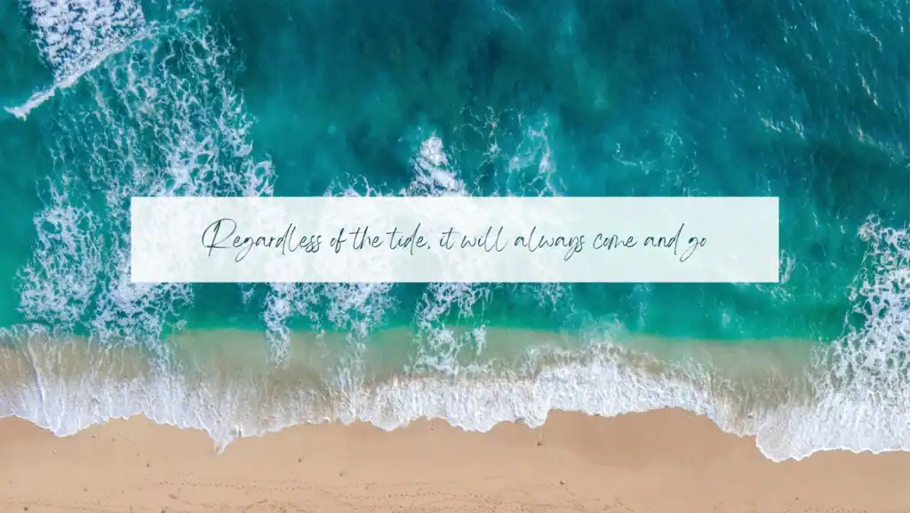 Inspirational quote on beach with ocean waves and sandy shore.