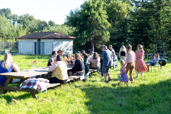 People gathered outdoors at Heirloom East Bay for a community event.